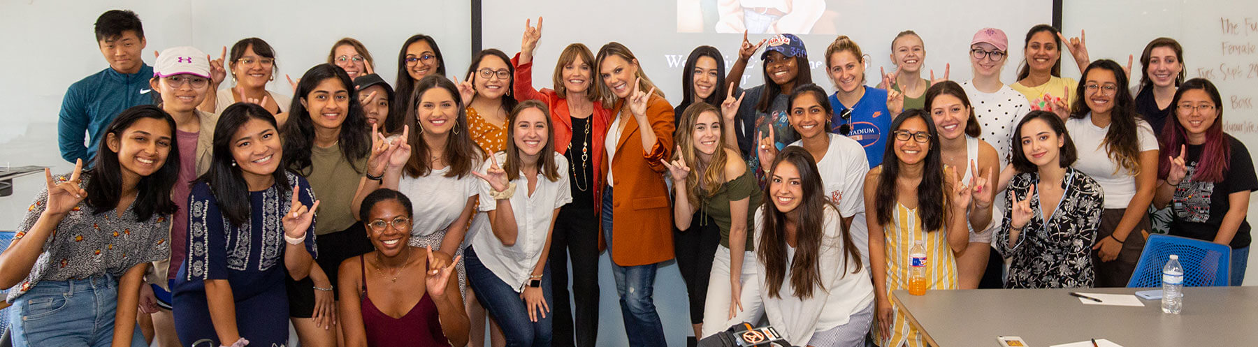 Kendra Scott taking a group photo with her students