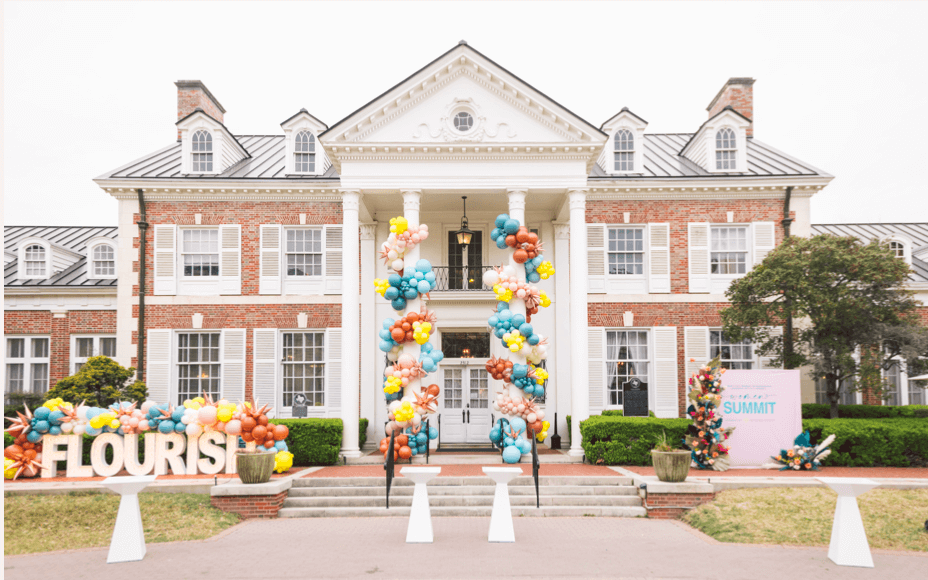 An image of a building with balloons displayed at the entrance