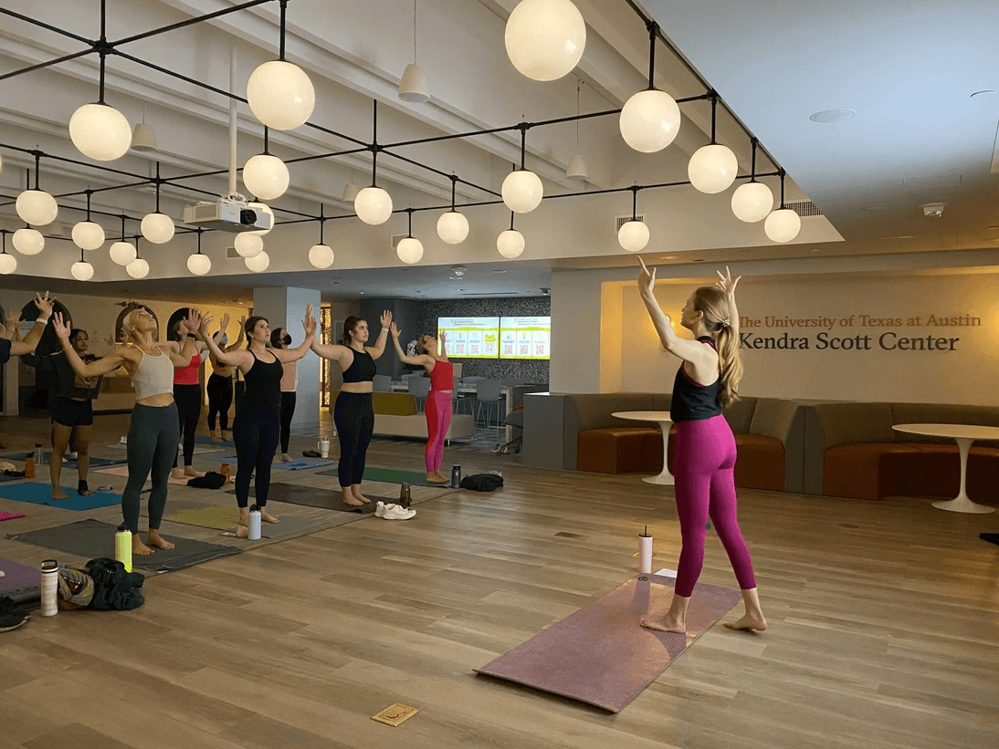 A yoga instructor leading a class at the Kendra Scott Center in the College of Fine Arts