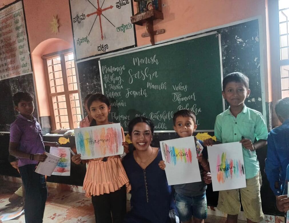 Kids holding up artwork with Sasha Kadamba